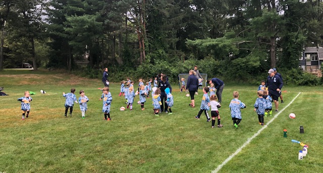 Instructional program kids playing on field